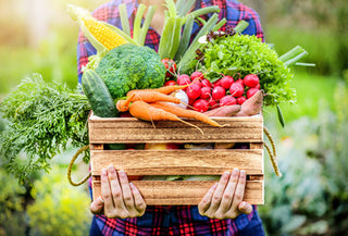 Person holding a container of fresh produce