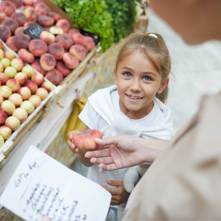 Two people grocery shopping for items on a list 