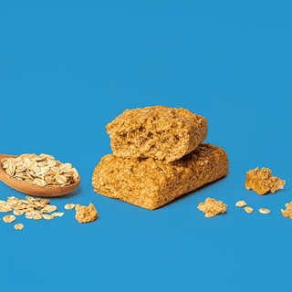 Bobo's Original Oat Bar split in half on a blue background