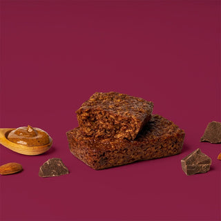 A close-up of a Chocolate Almond Brownie Oat Bar with cocoa, almond butter, and whole grain oats. Gluten-free, vegan, and dairy-free snack rich in flavor.